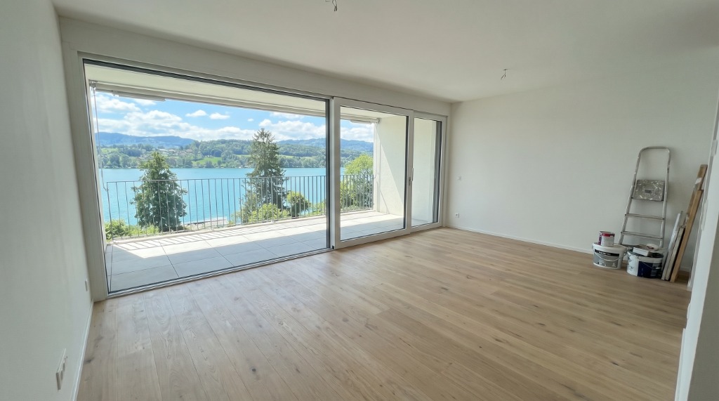 Vacant luxury condo living room in Toronto with hardwood floors and lake views